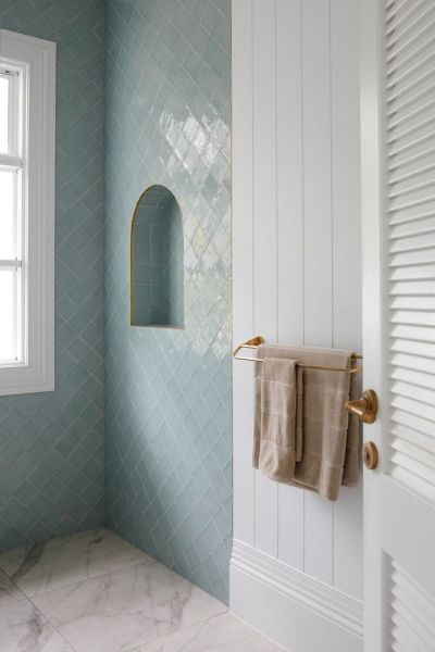 The Inspiration — the Leading Lady of the bathroom — square tile that looks handcrafted, in varying shades of blue, set in a fresh, modern diamond pattern.