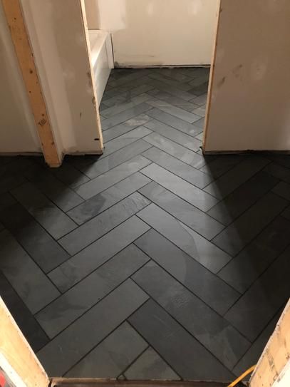 The Inspiration — graphite floor tile in a herringbone pattern.